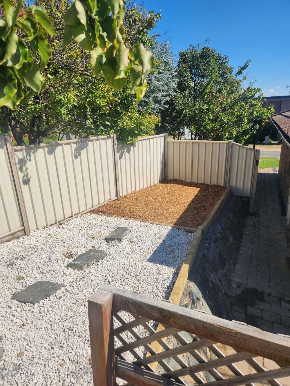 After A Backyard With A White Fence And Gravel — Canberra Home and Garden Maintenance in Tuggeranong ACT