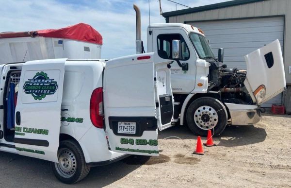 A white van is parked next to a truck  | HHO Carbon Clean Systems - North Atlanta