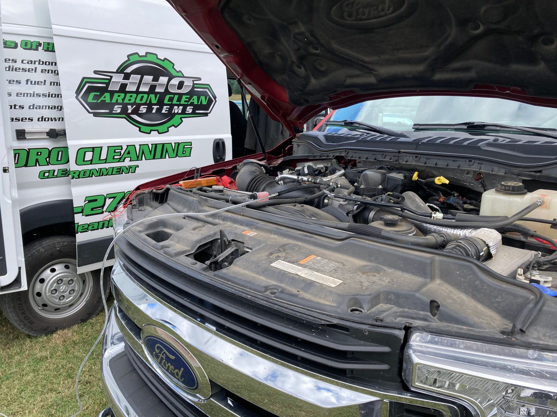 The hood of a ford truck is open and the engine is visible | HHO Carbon Clean Systems - North Atlanta