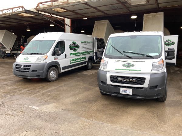 Two ram vans are parked next to each other in a parking lot | HHO Carbon Clean Systems - North Atlanta