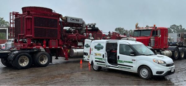 A white van is parked next to a red semi truck | HHO Carbon Clean Systems - North Atlanta