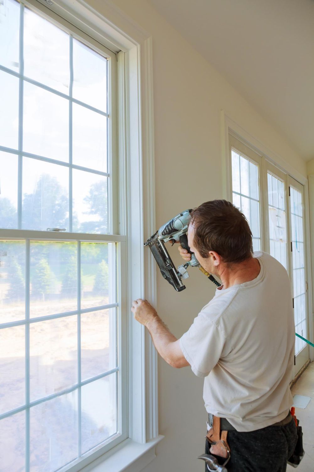 Person adjusting valves on a complex plumbing system with various pipes, gauges, and controls.