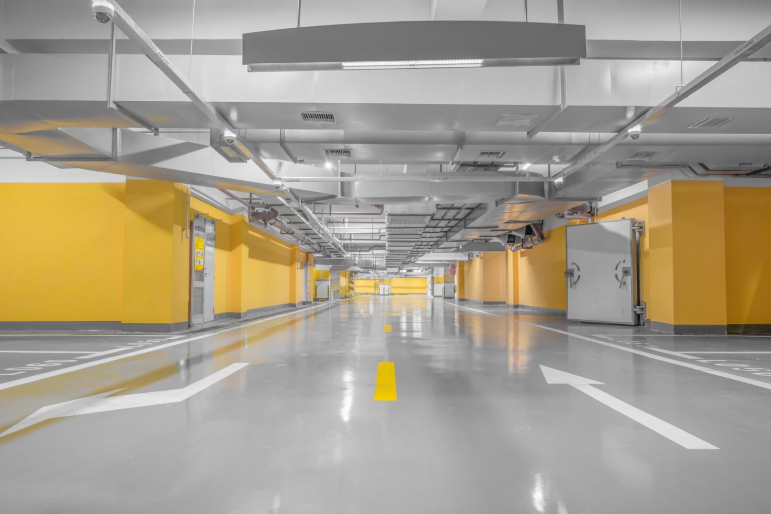 Two people in orange safety gear work in floodwaters, one making splash.