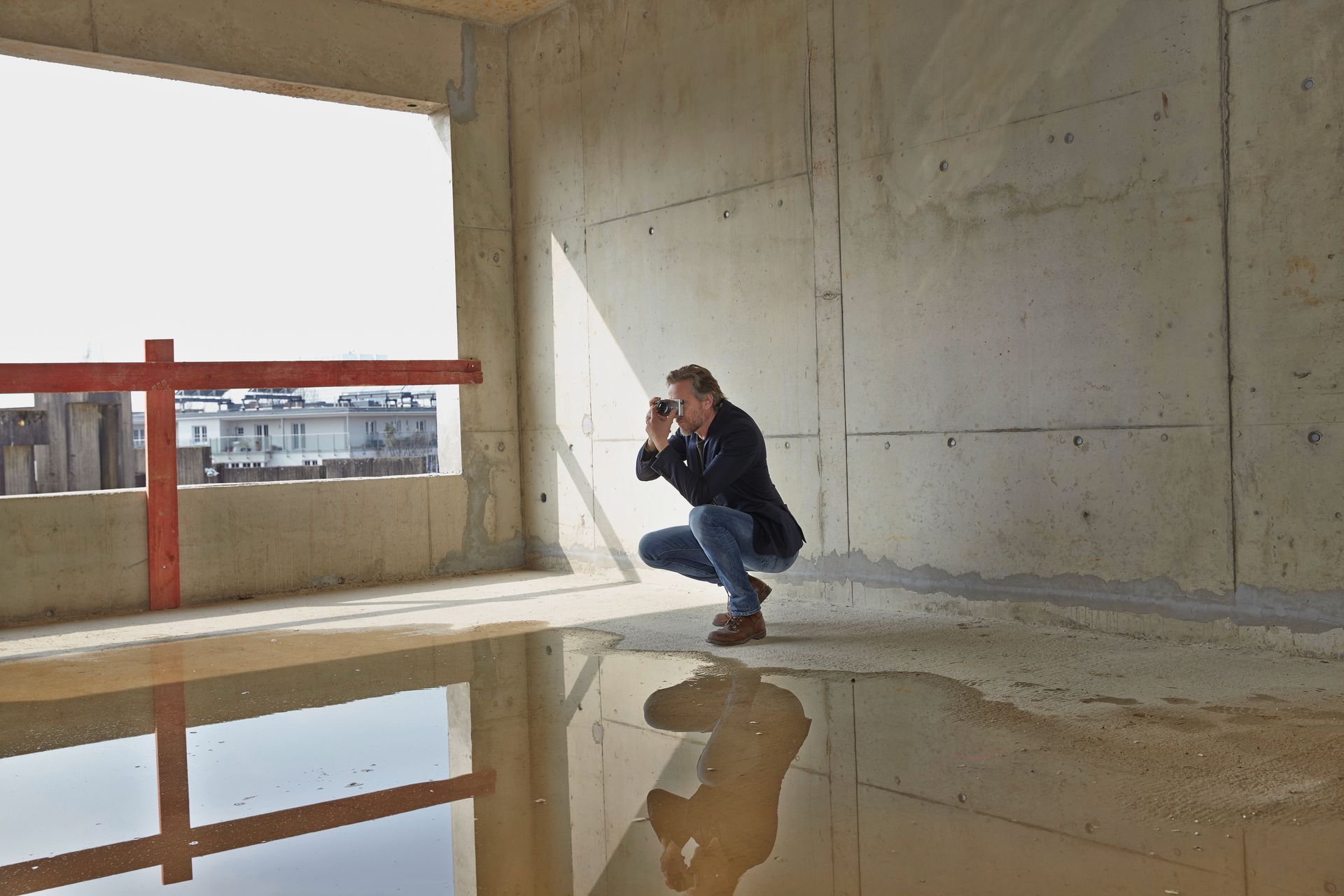 Man taking picture on construction site to survey for water damage