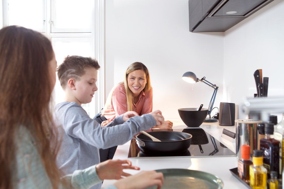 A happy family enjoying their newly remodeled kitchen - kitchen remodel denver cost