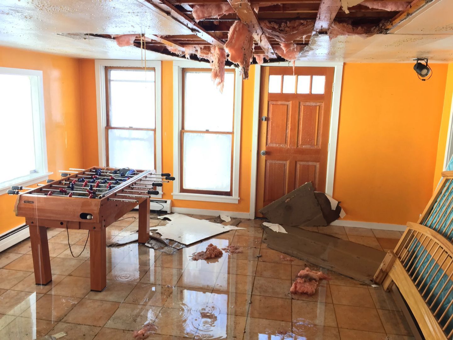 A flooded room with a foosball table Denver Colorado how to get rid of water damage