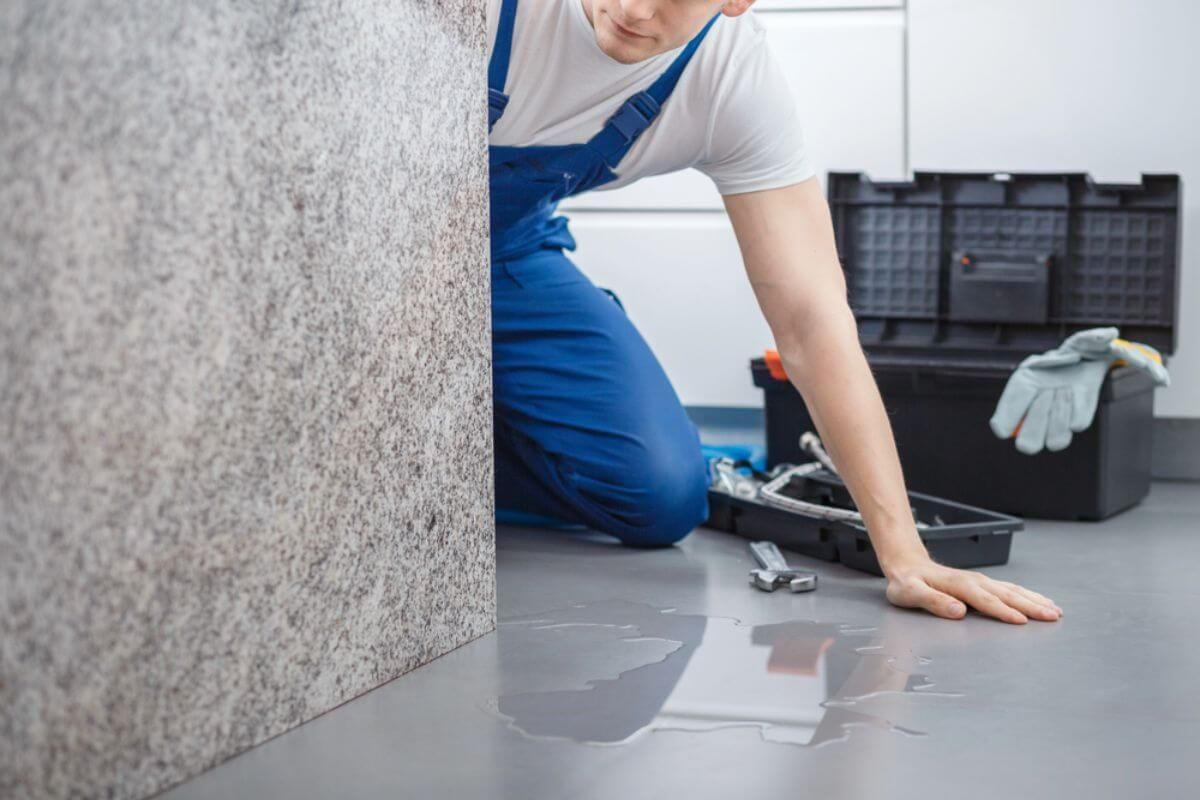 a man inspecting the floor Denver Colorado how to deal with water damage