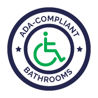 A logo for ada compliant bathrooms with a handicapped person in a wheelchair.