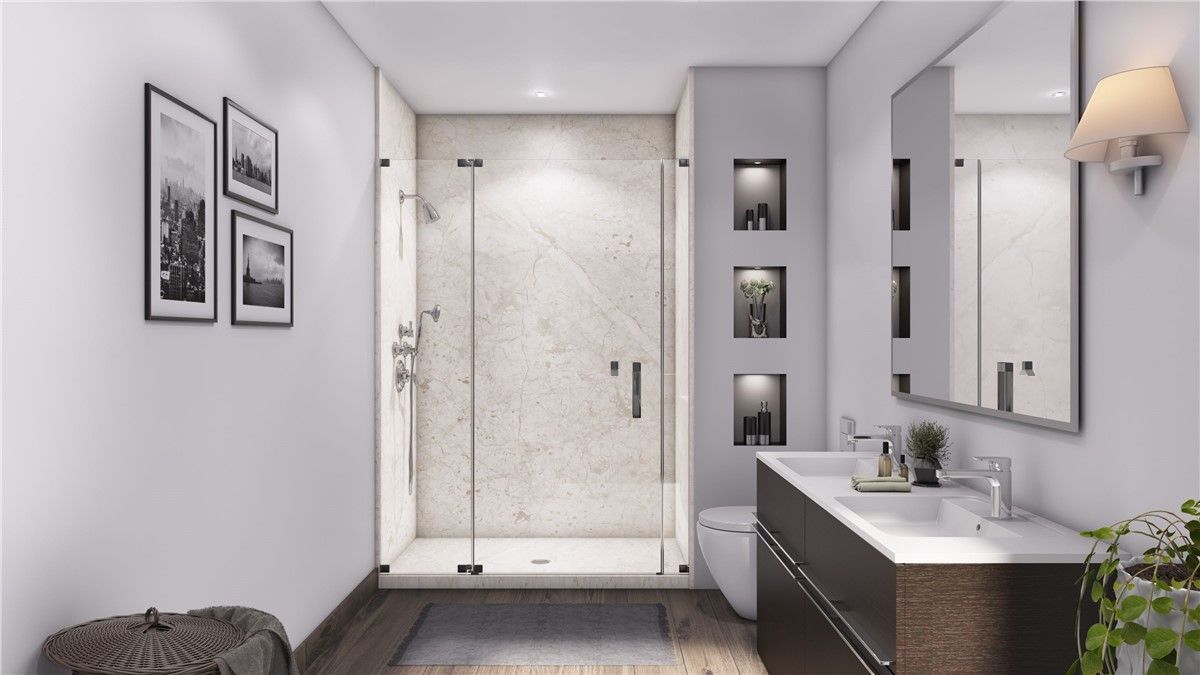 A bathroom with a walk in shower , sink , toilet and mirror.