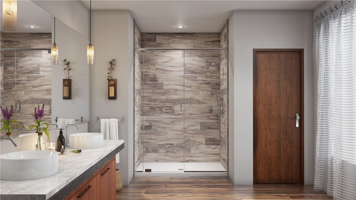 A bathroom with two sinks and a walk in shower.