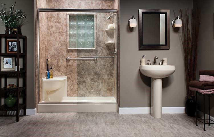 A bathroom with a shower , sink and mirror.