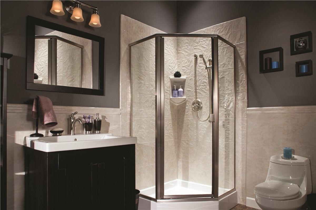 A bathroom with a shower , sink , toilet and mirror.