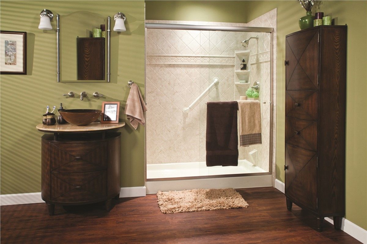 A bathroom with a walk in shower and a sink