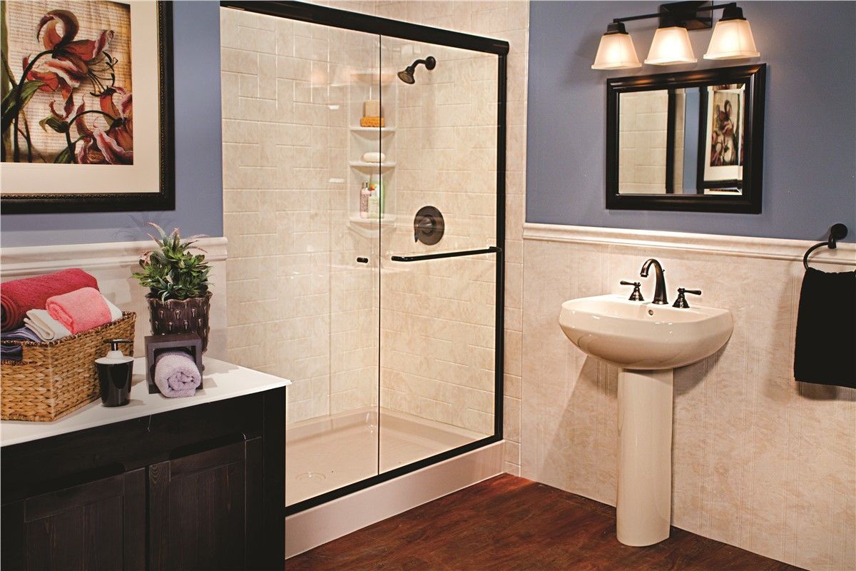 A bathroom with a sliding glass shower door and a sink