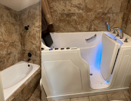 A bathroom with a walk in tub and a bathtub