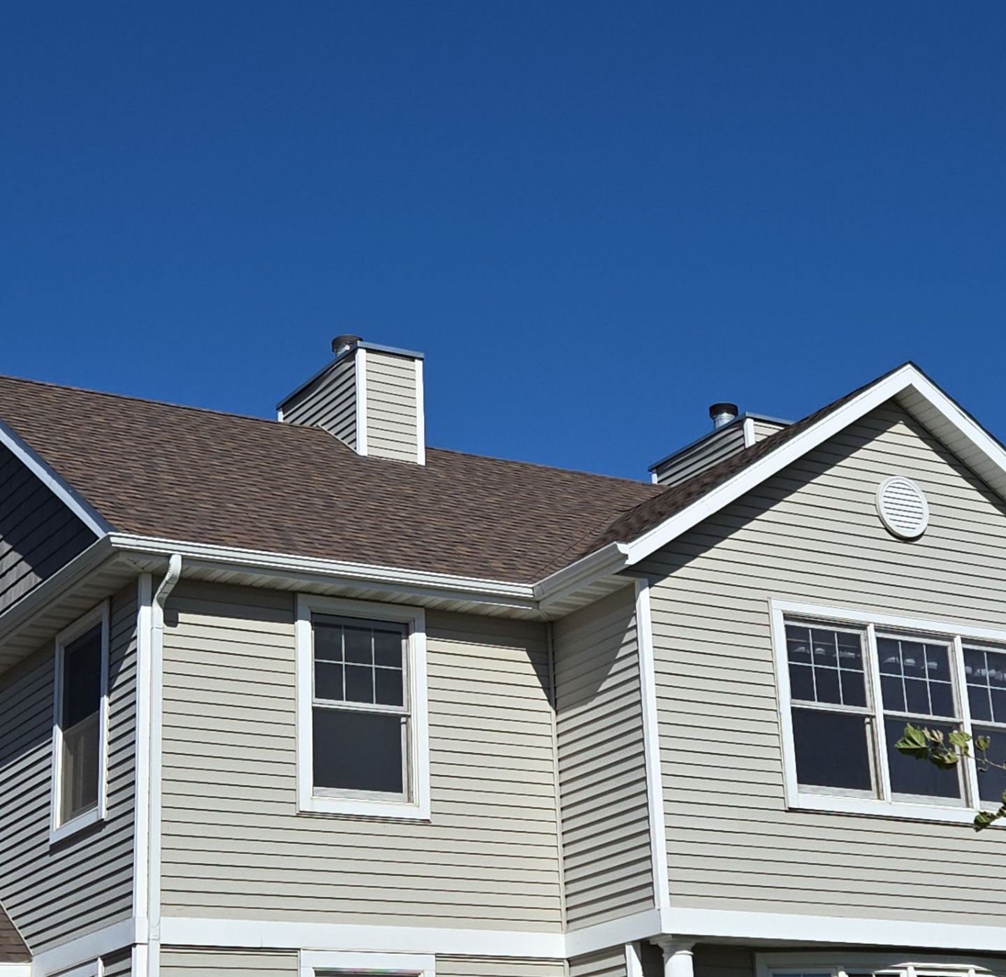 The roof of a house under construction with a blue sky in the background.