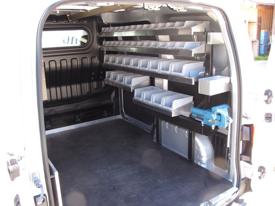 Das Innere eines weißen Lieferwagens mit Regalen und Schubladen