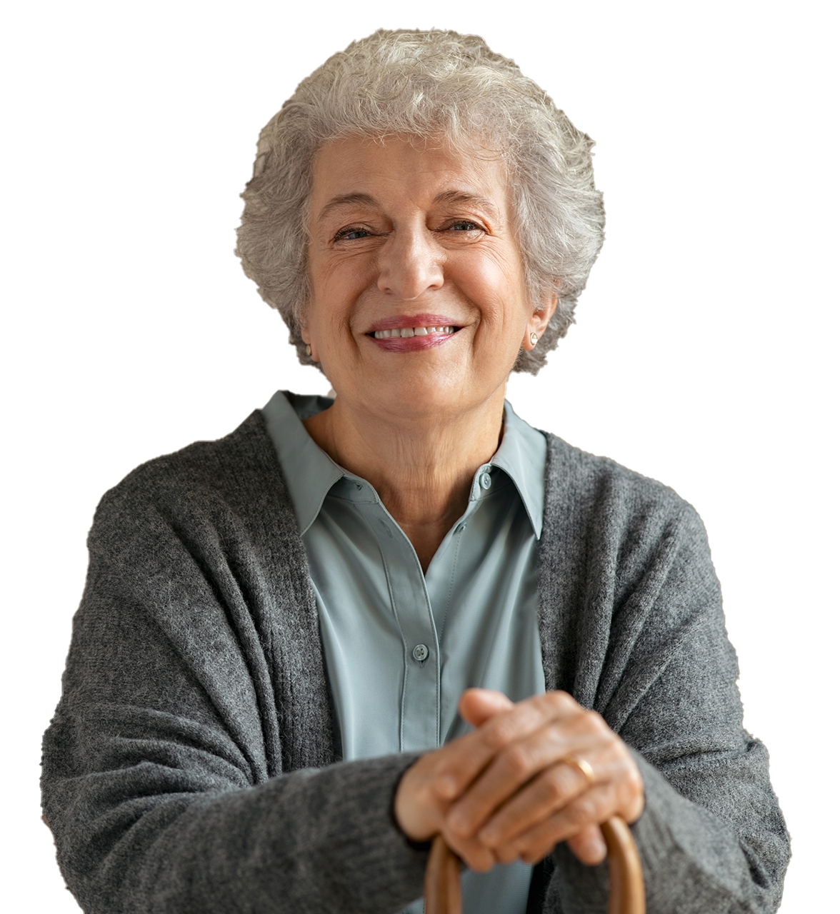 An elderly woman is smiling and holding a cane