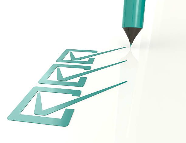 A nurse is sitting on a couch talking to a patient.