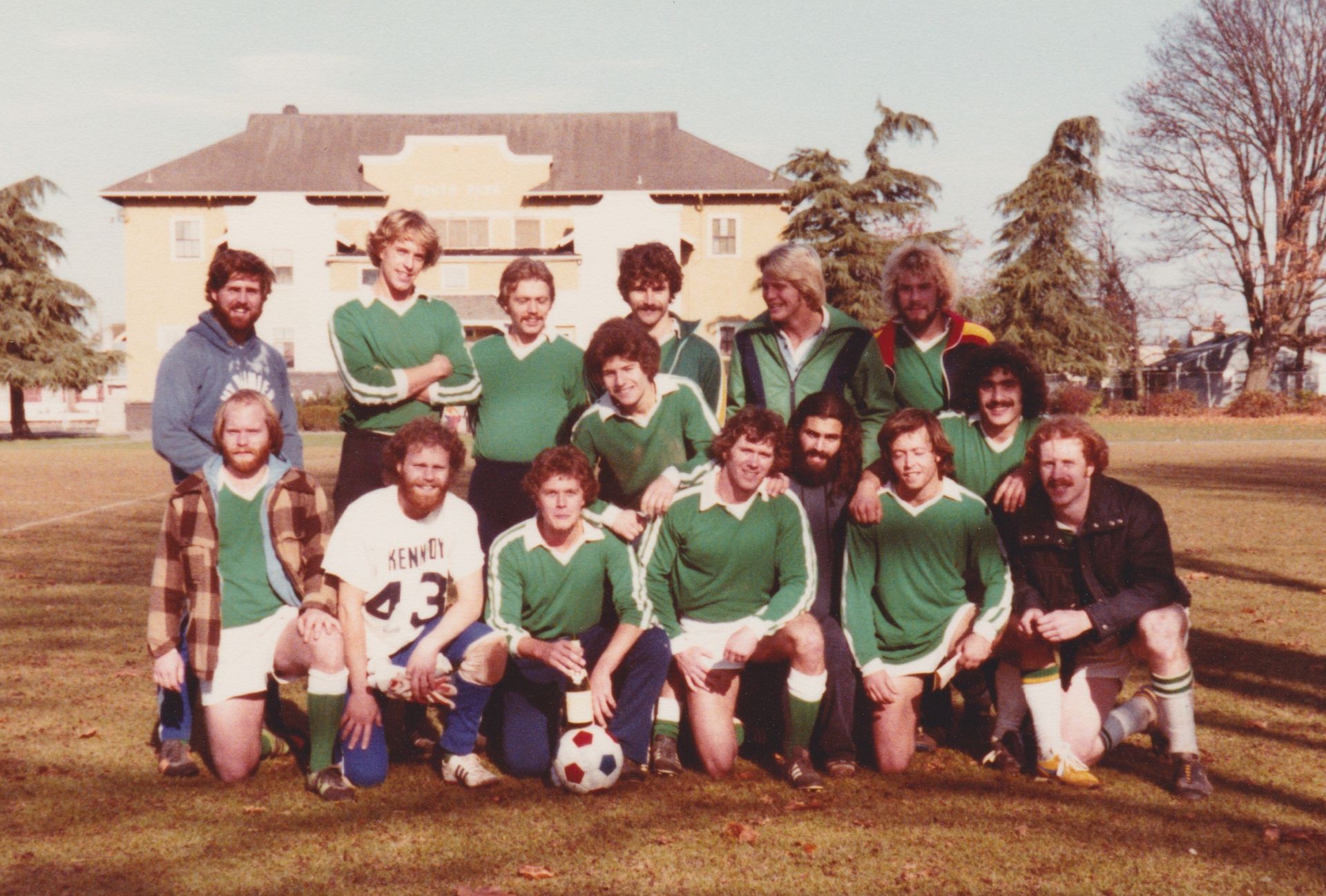 Baseball player sliding into base as another player attempts to catch the ball.
