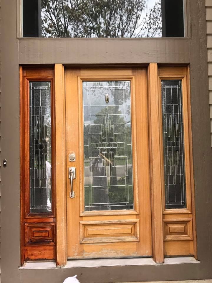 A wooden door with stained glass windows on a house.