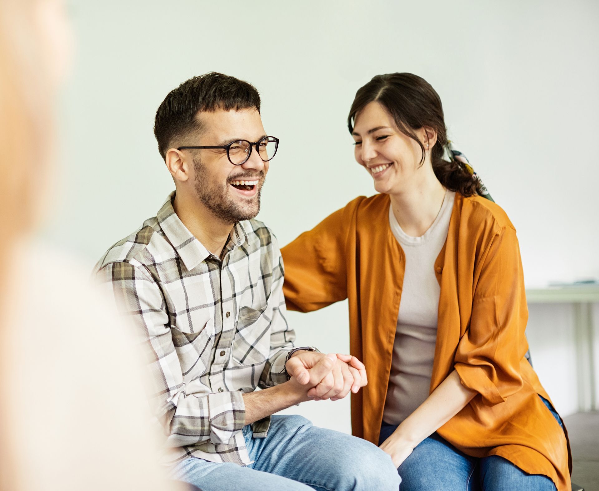 a man and a woman are sitting happily next to each other