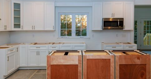 front view of kitchen cabinets and shelves remodel in residential home , all white cabinets, brown kitchen counters.
