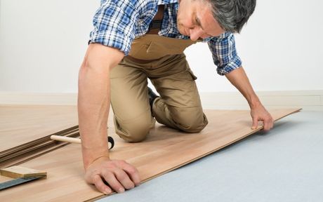 arlington heights carpenter installing laminate flooring in residential home floor.