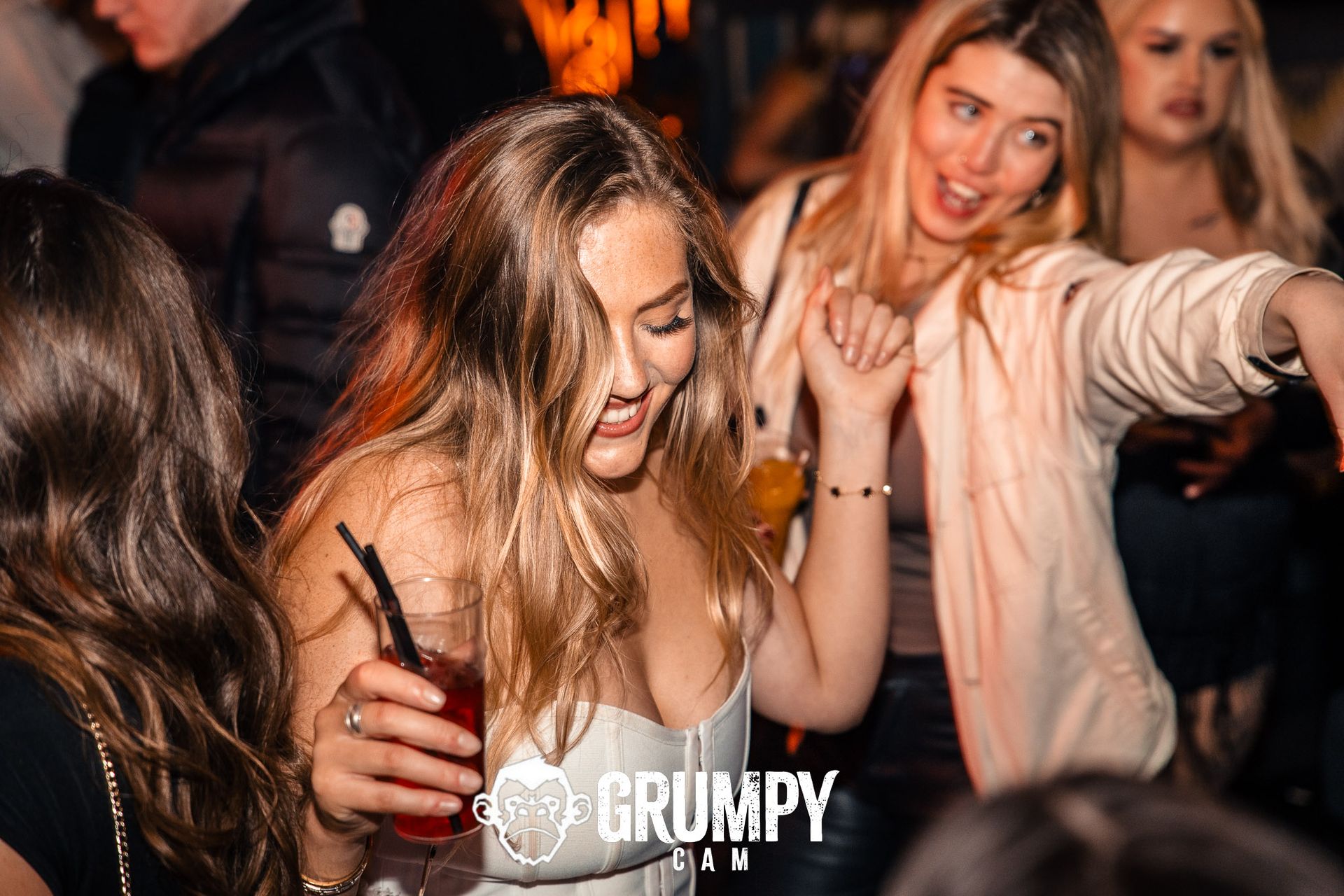 A group of women are dancing in a club.
