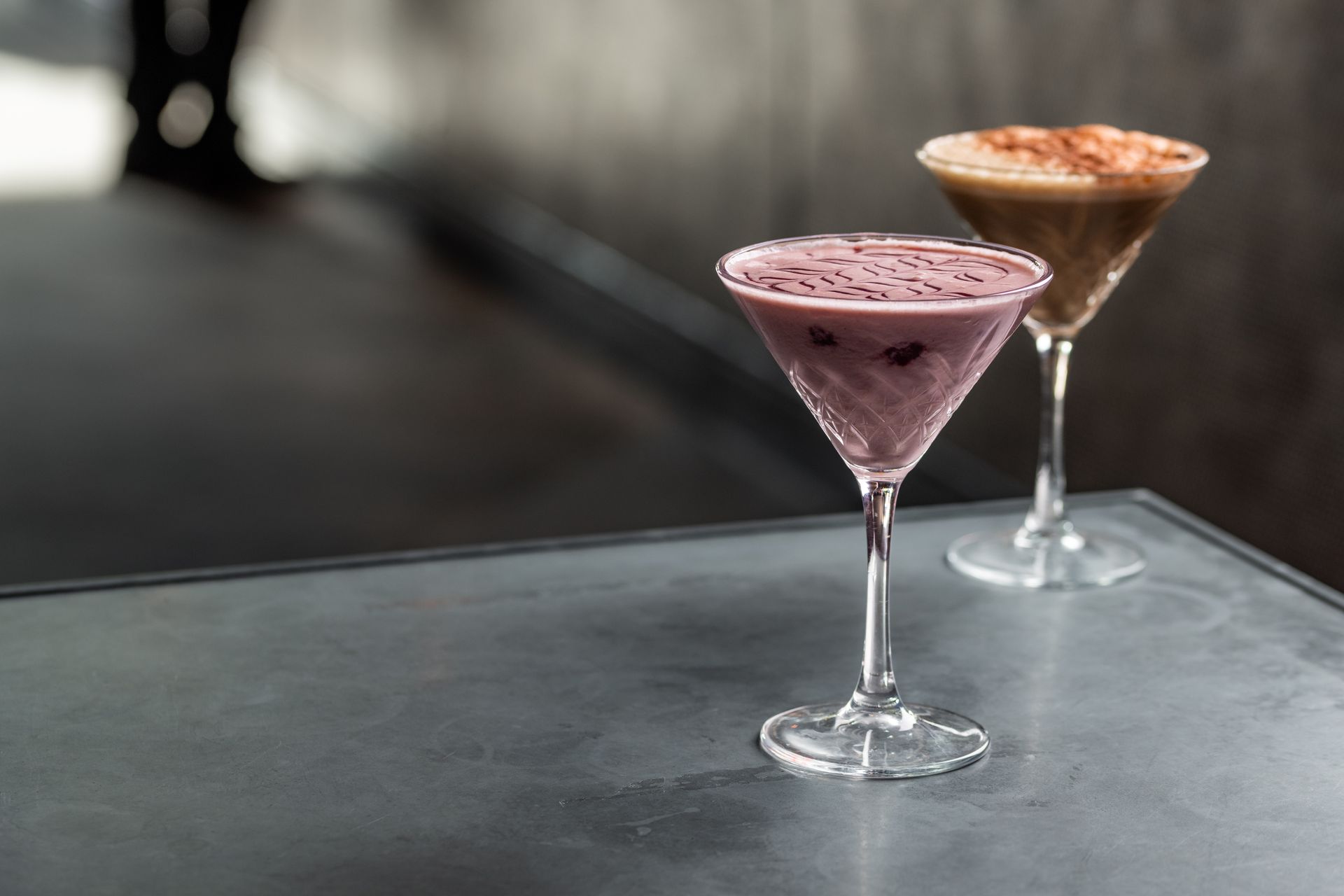 Two martini glasses are sitting on a table