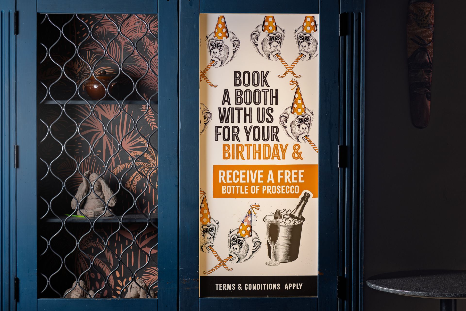 A sign that says book a booth with us for your birthday and receive a free bottle of prosecco