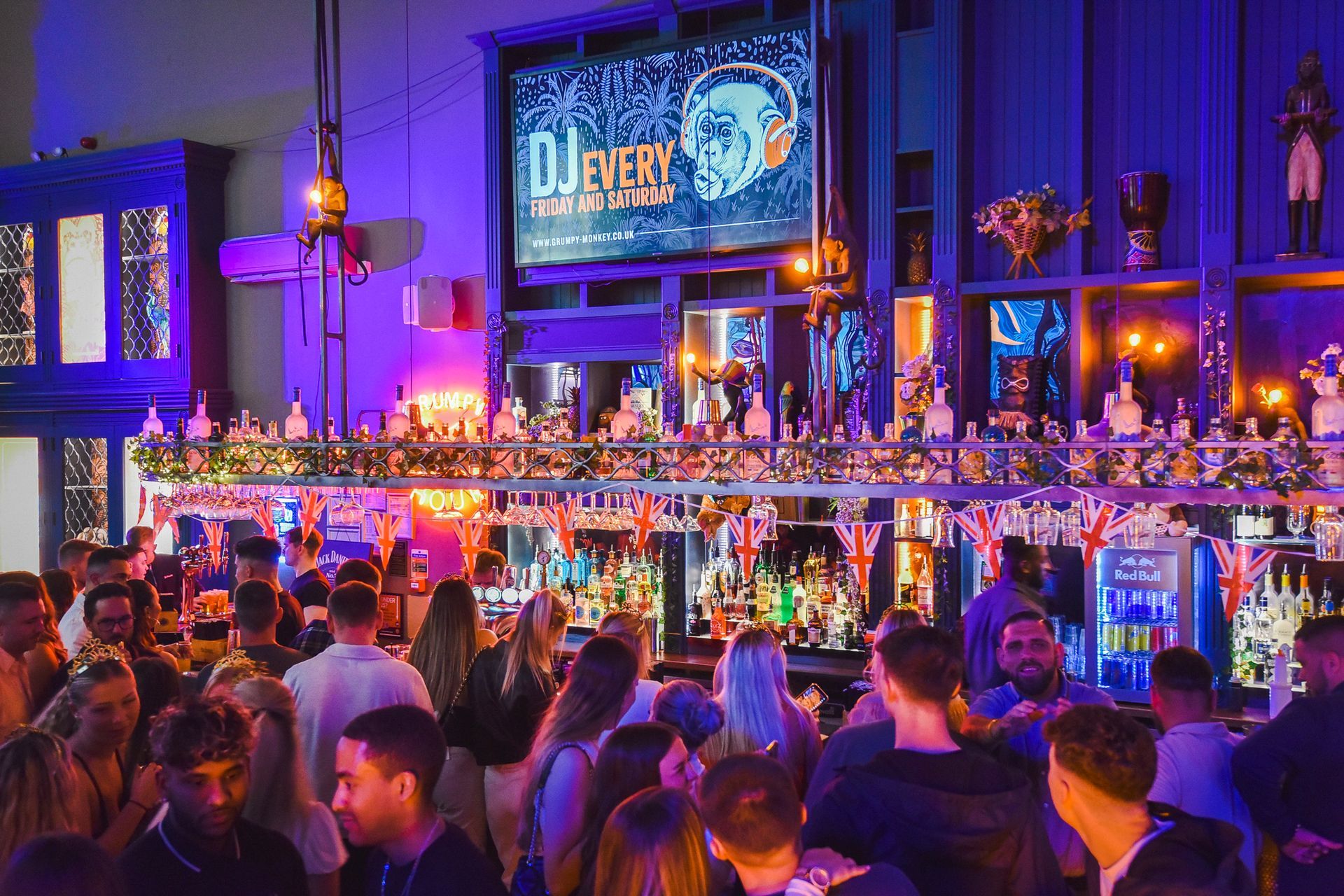 A crowd of people are gathered at a bar.