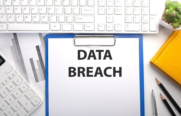 A clipboard with the words `` data breach '' written on it.