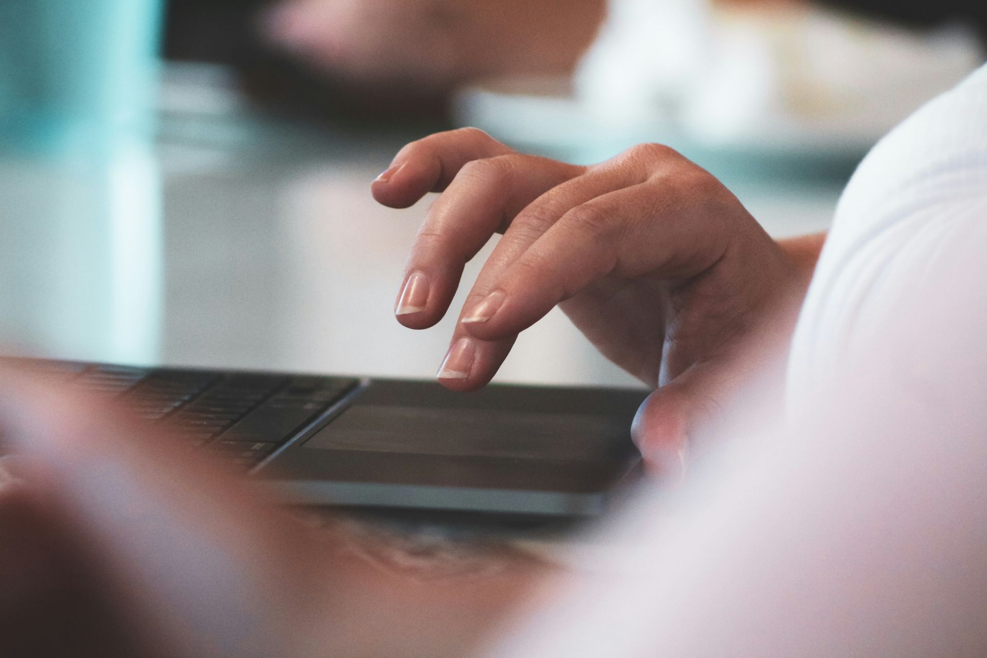 A person is typing on a laptop computer.