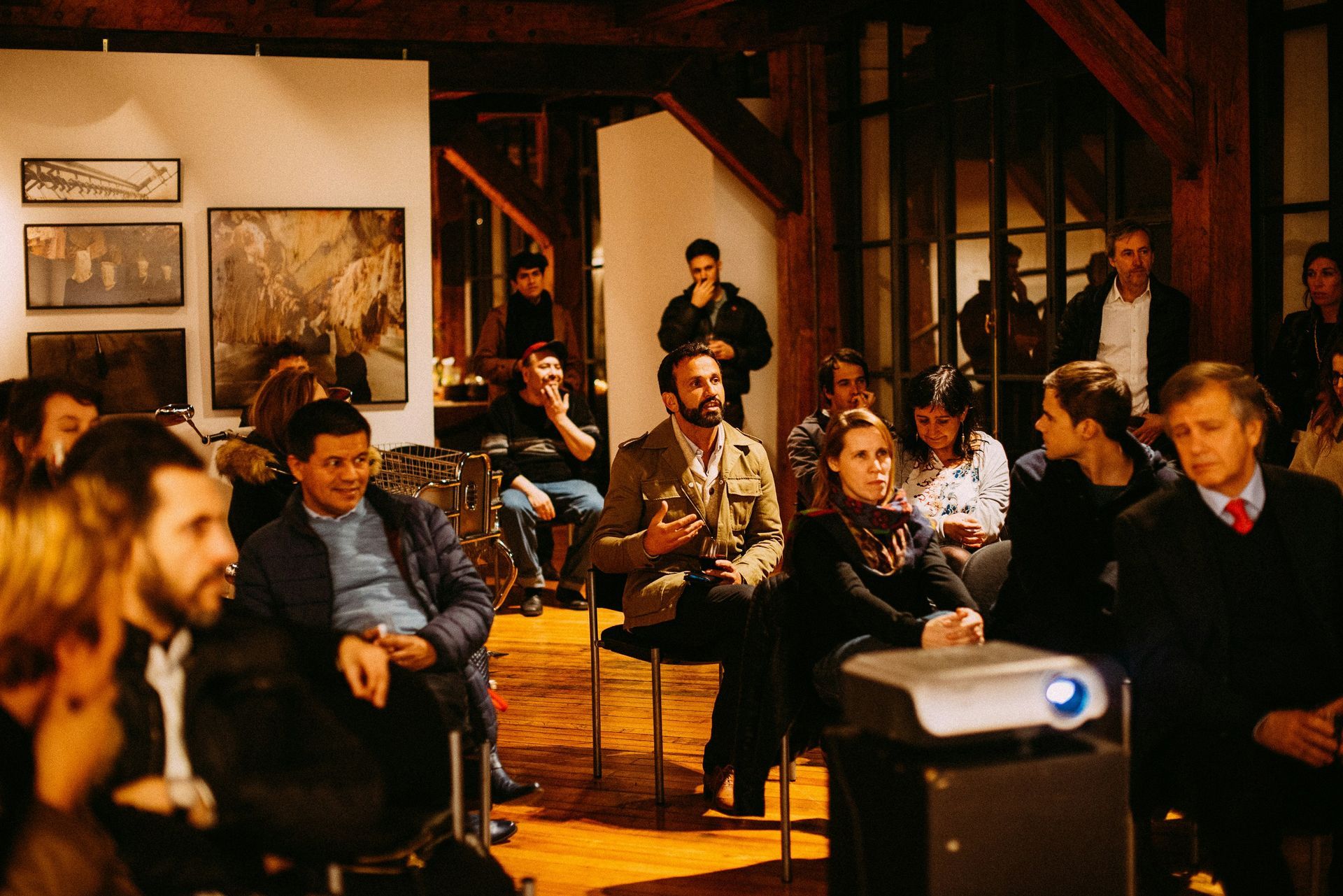 A group of people sitting in chairs in front of a projector