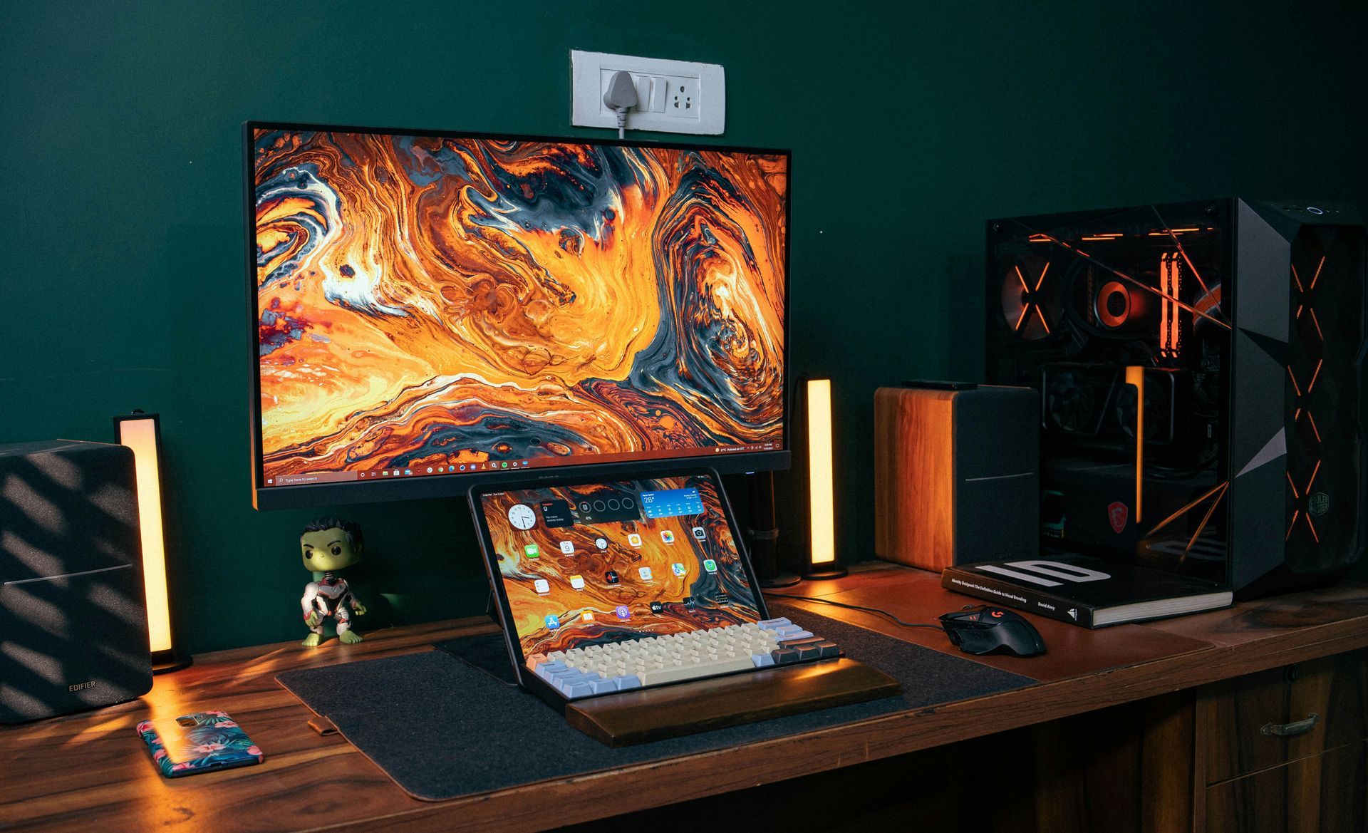 A computer desk with a laptop , monitor , keyboard , mouse and speakers.