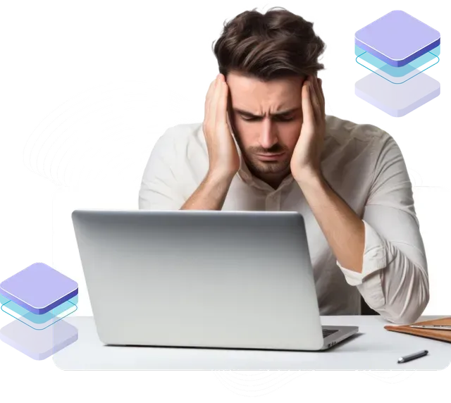 A man sitting in front of a laptop with his hands on his head