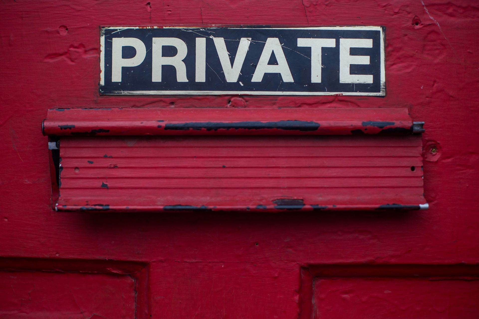 A red door with a private sign on it.