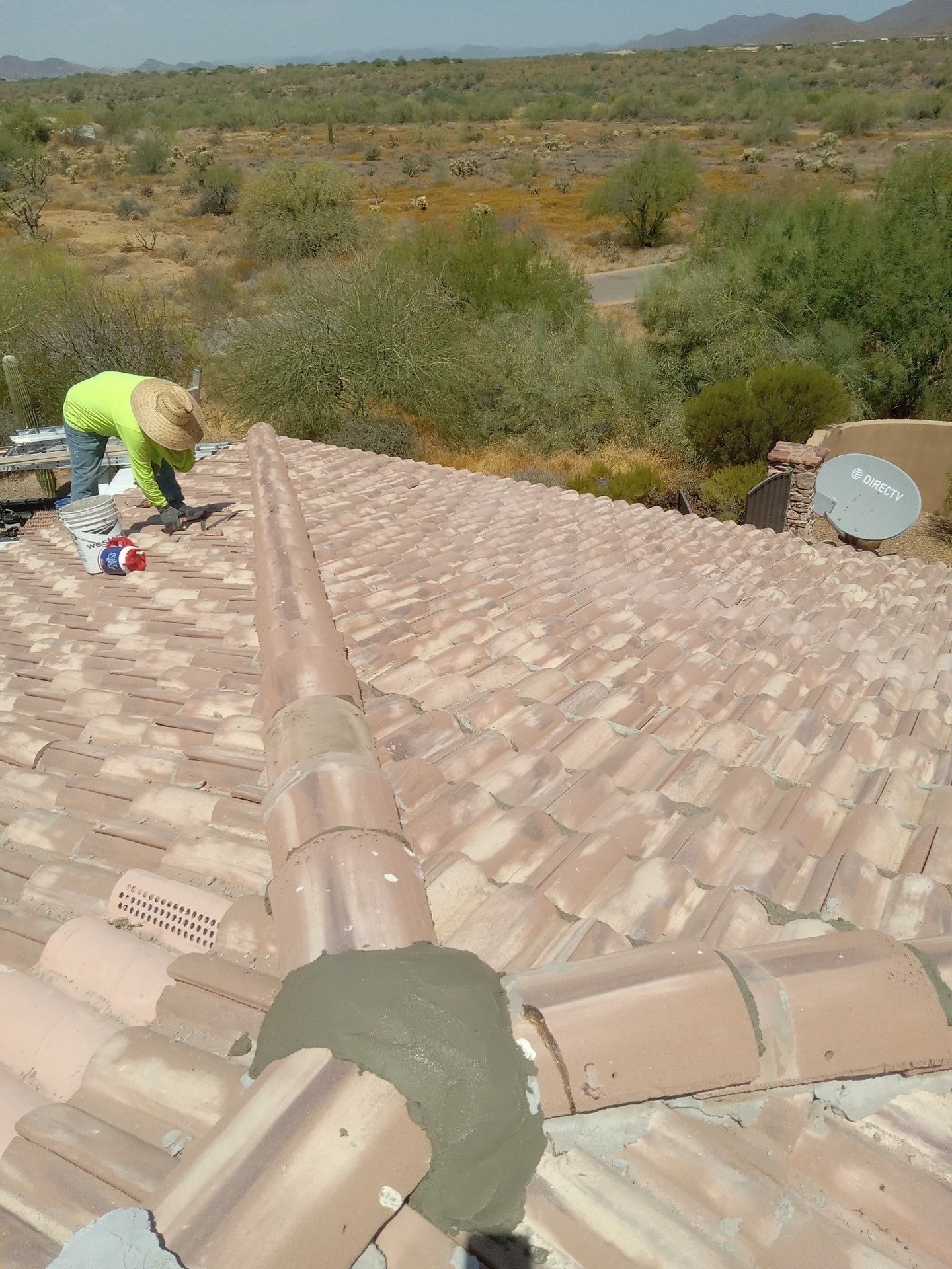 A person is working on the roof of a house