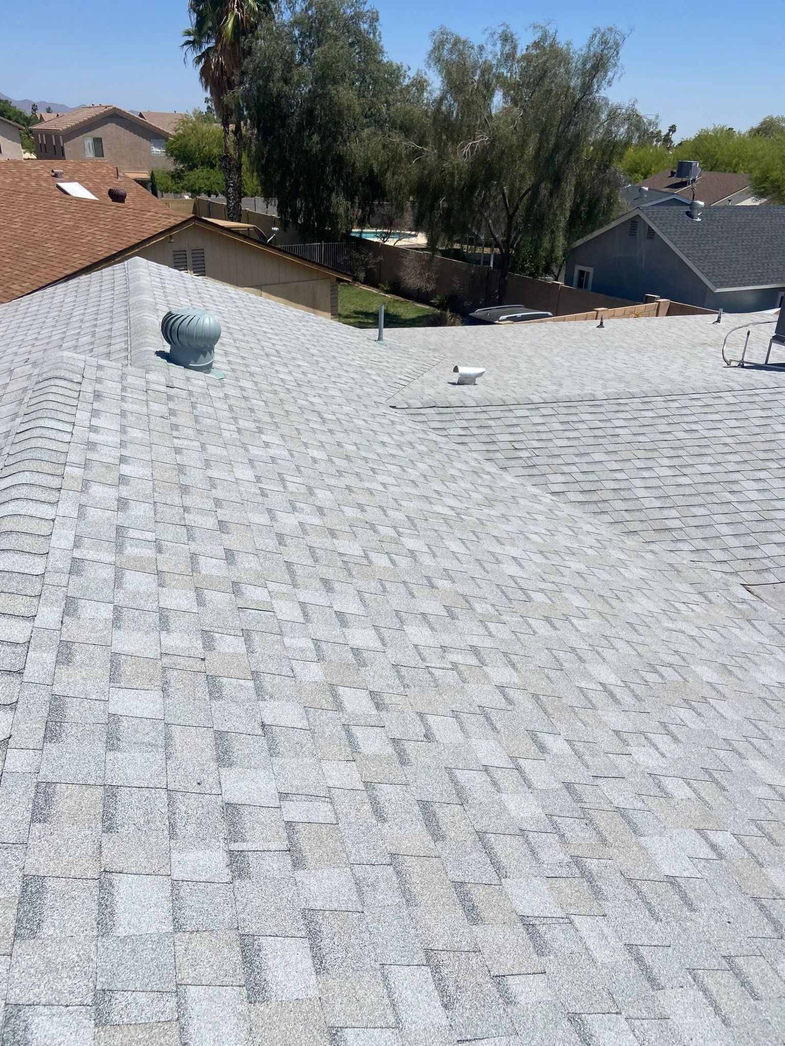 A close up of a roof with a fan on it.