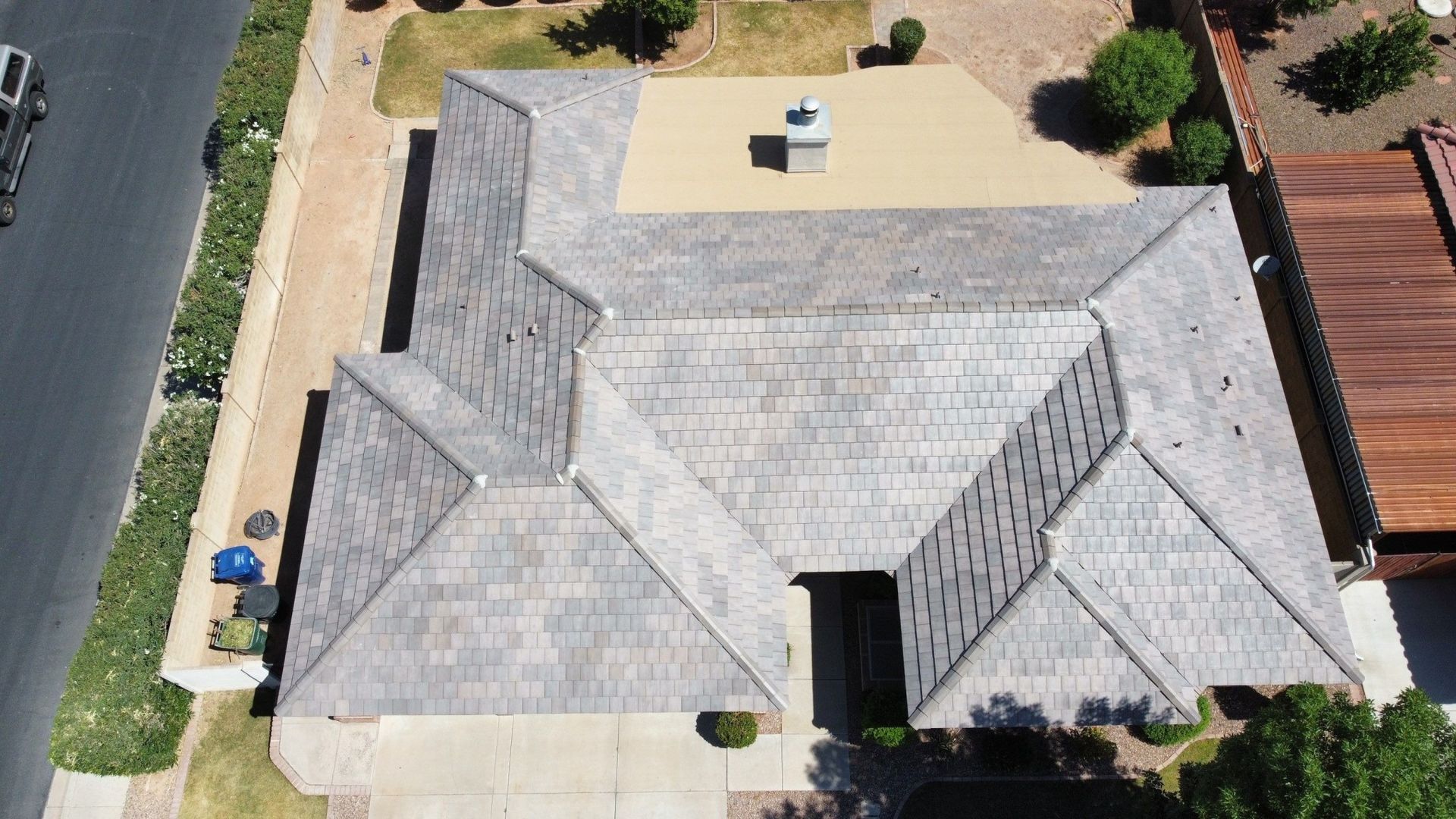 An aerial view of a house with a gray roof.