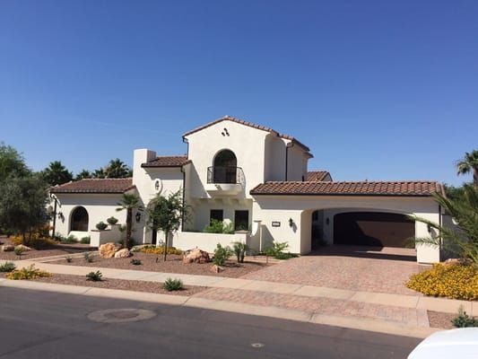 A large white house with a car parked in front of it