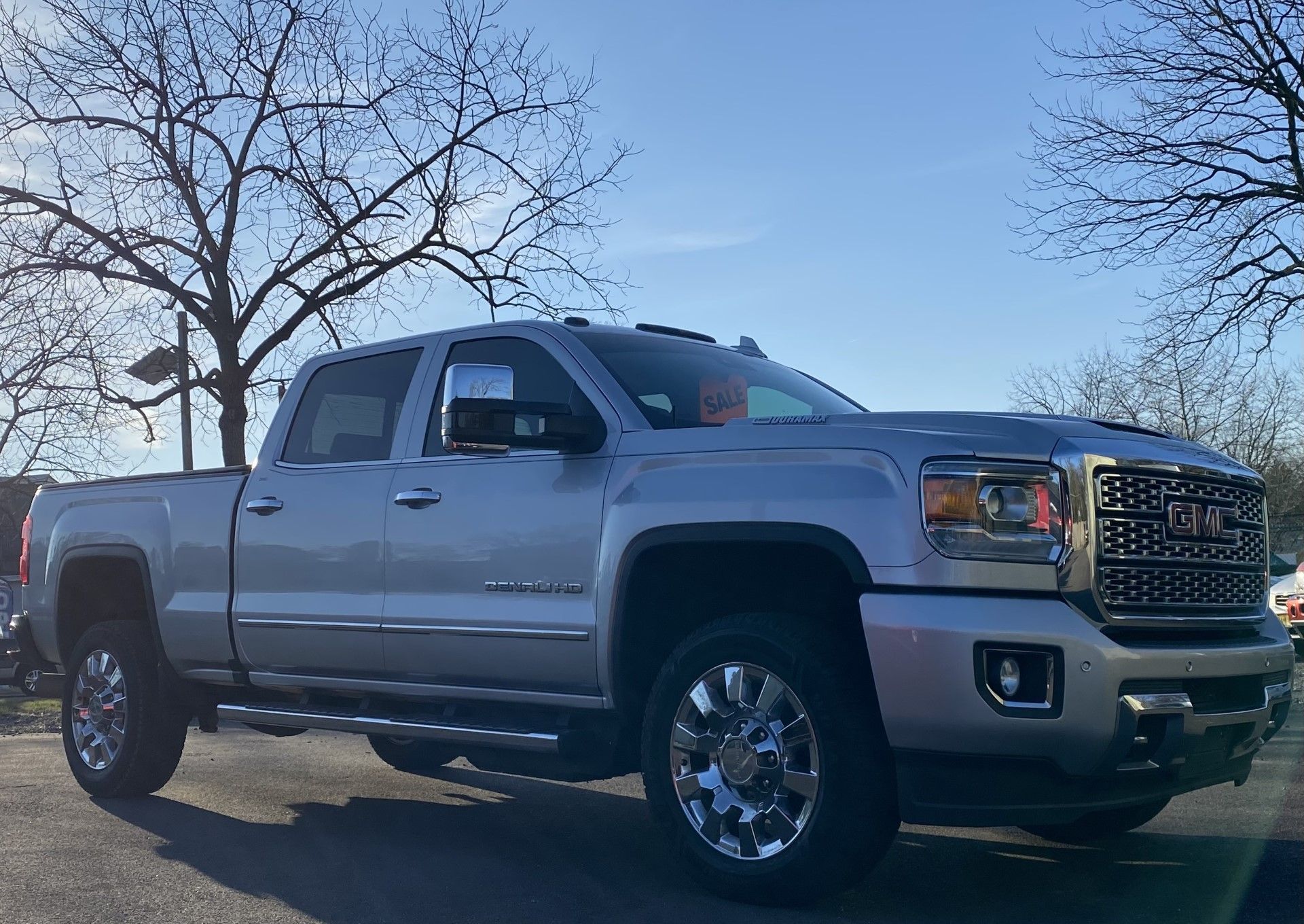 A silver gmc truck is parked in a parking lot. | InTown Auto Care