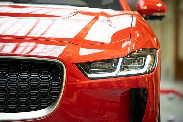 A close up of the front of a red car. | InTown Auto Care