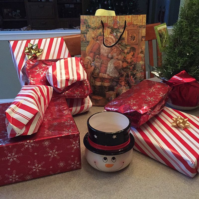 A pile of christmas presents including a snowman mug | InTown Auto Care