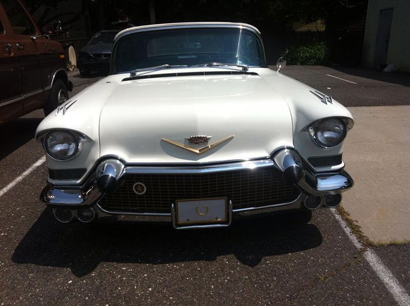 A White Cadillac is Parked Nearby InTown Auto Care