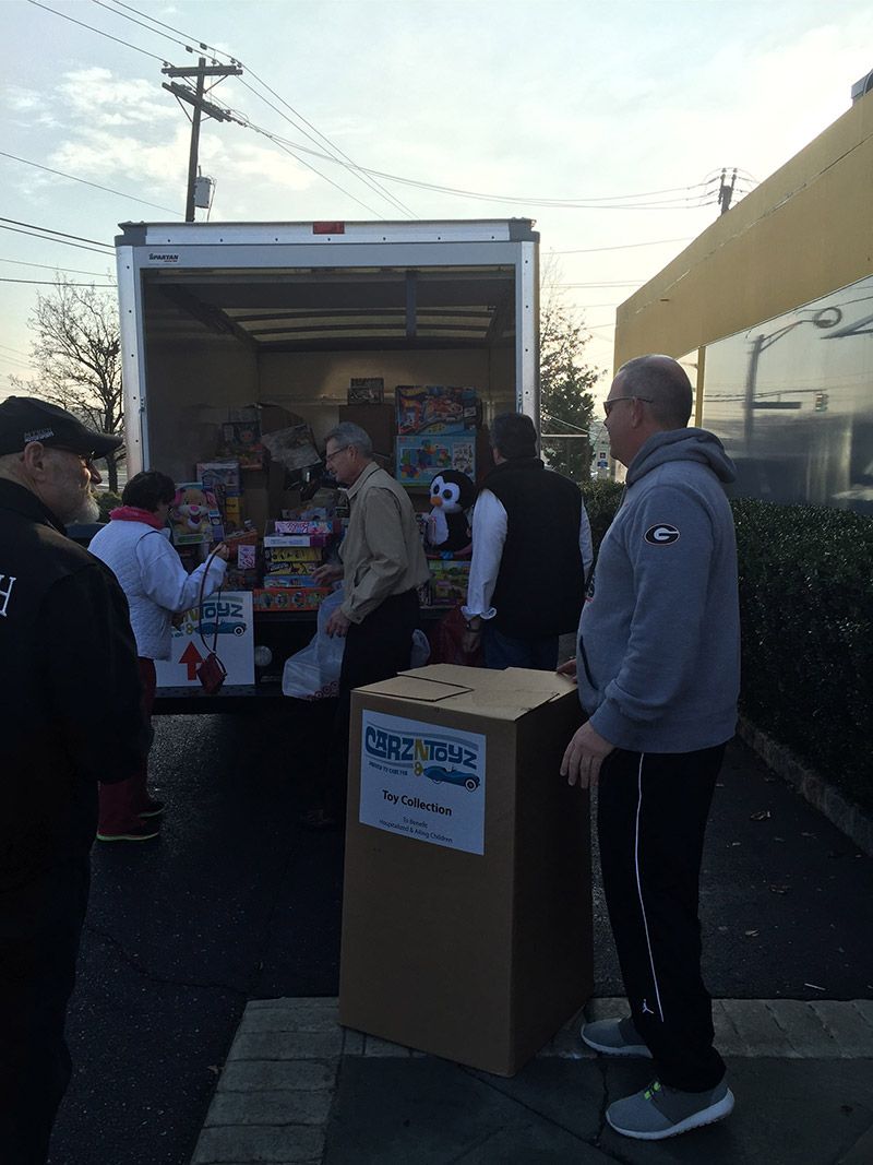 A group of people are standing in front of a truck. | InTown Auto Care