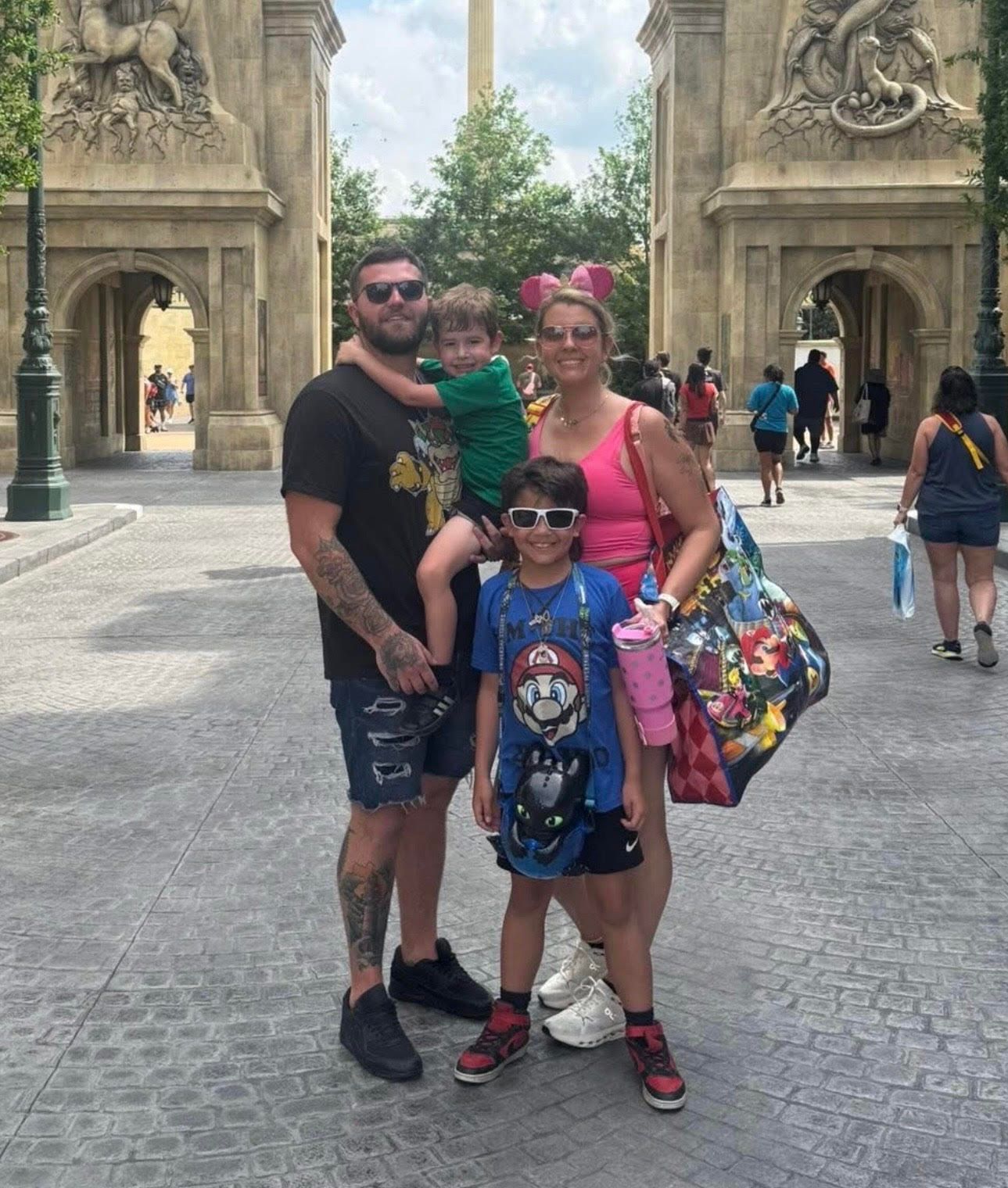A family posing for a picture with mickey mouse and minnie mouse | InTown Auto Care