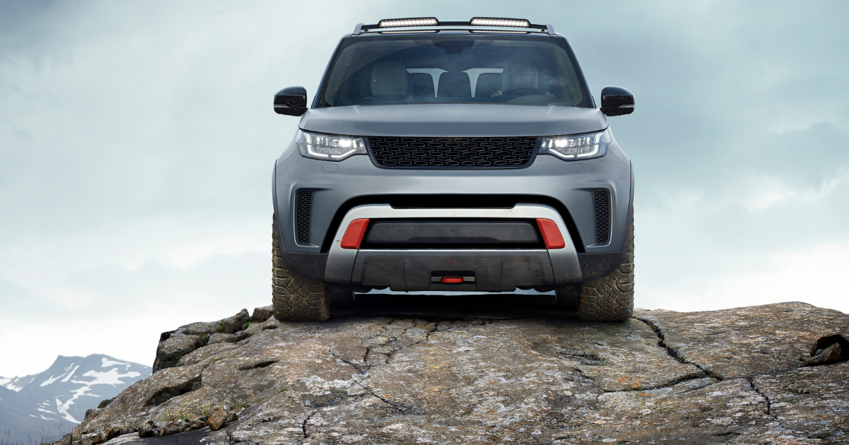 A silver land rover discovery is parked on top of a rocky hill. | InTown Auto Care