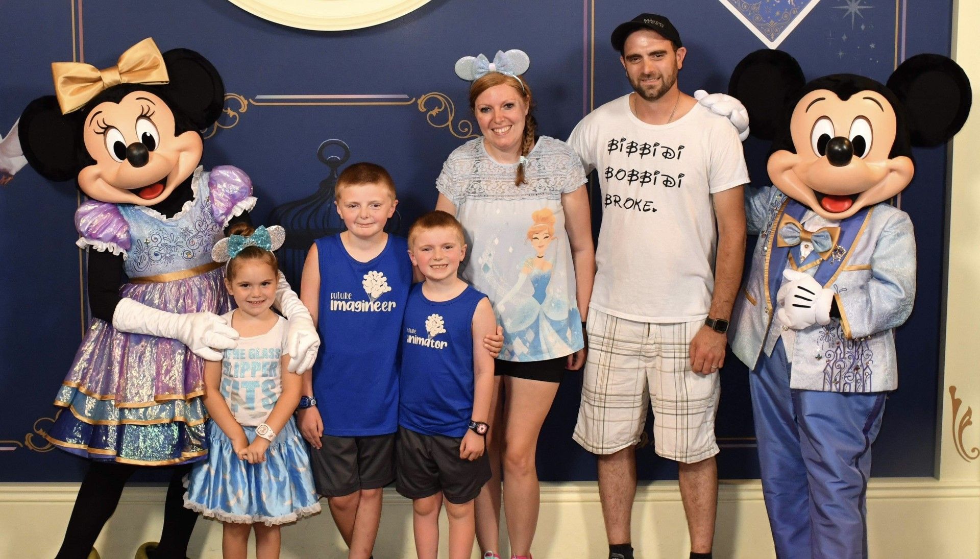 A family posing for a picture with mickey mouse and minnie mouse | InTown Auto Care